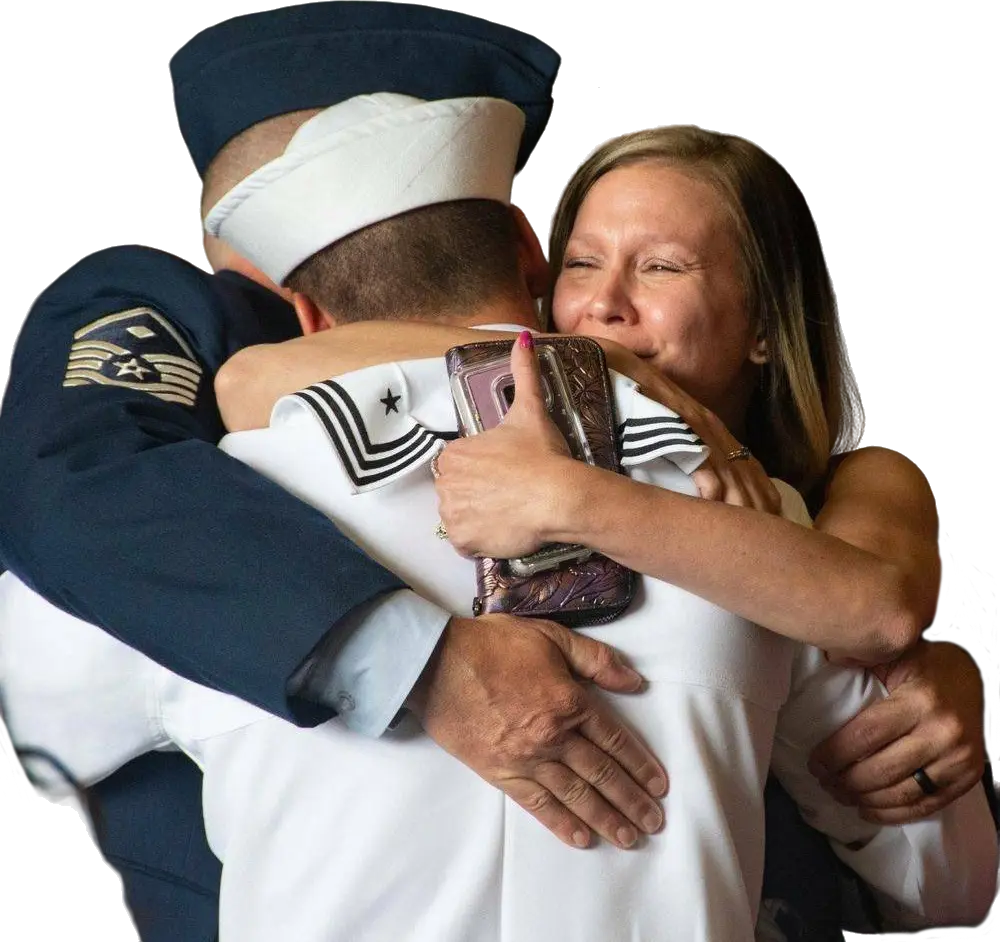 Sailor in dress whites embracing mother and father after graduation